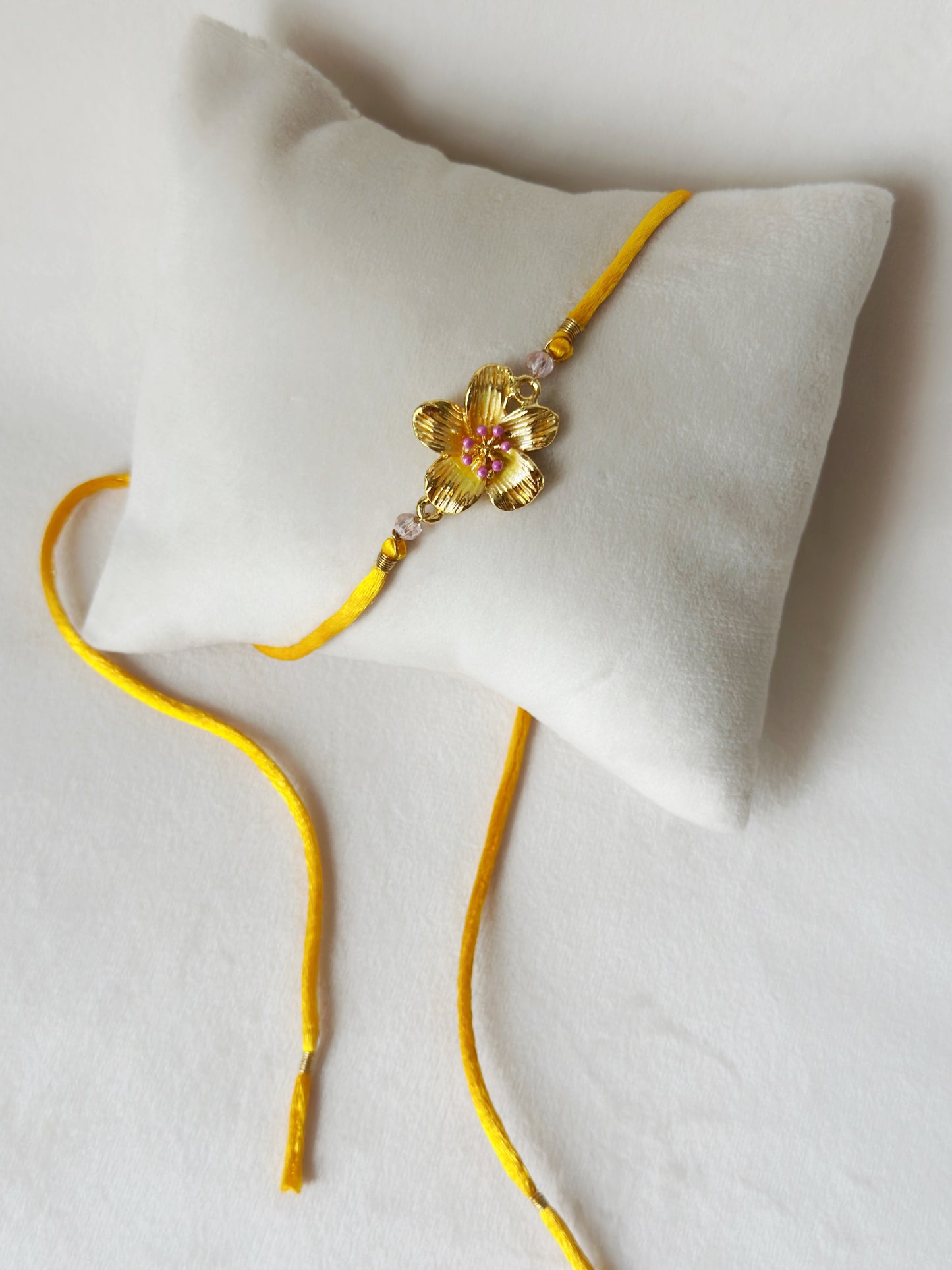 Floral Rakhi Small Gold, pink and saffron