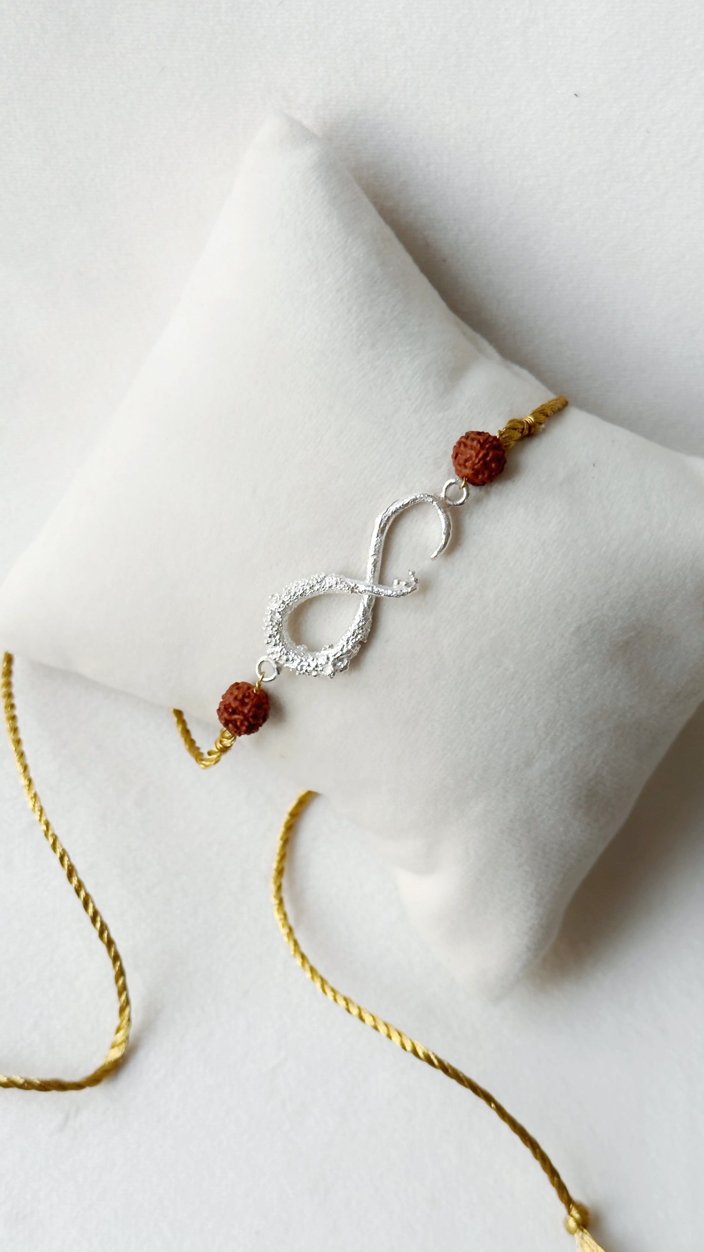 Infinity Rakhi Silver and Gold with Rudraksh beads