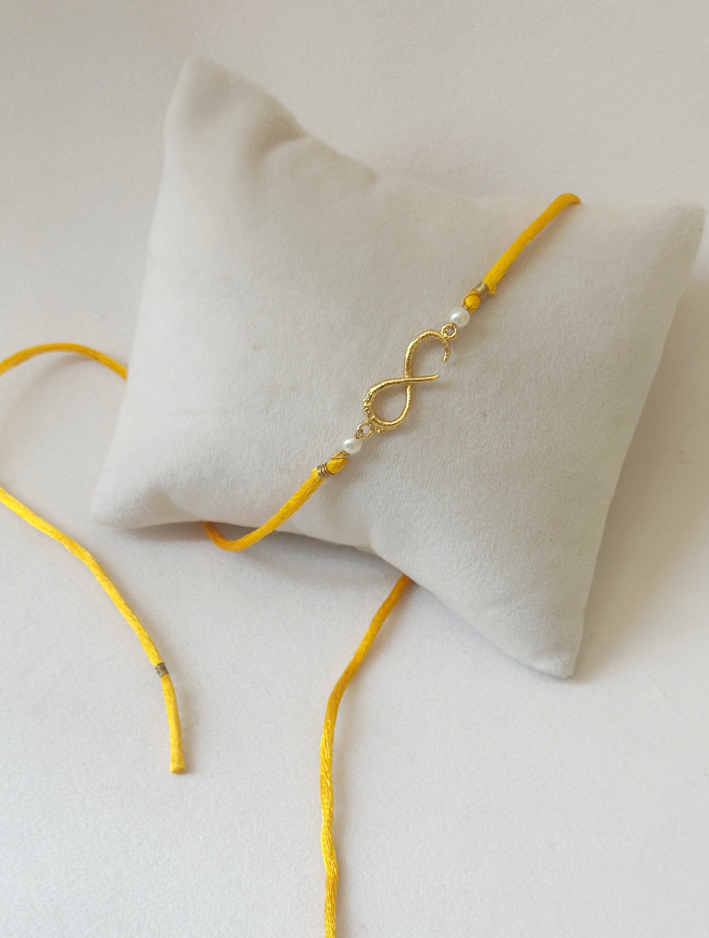 Small Infinity Rakhi Gold and Saffron with Pearls