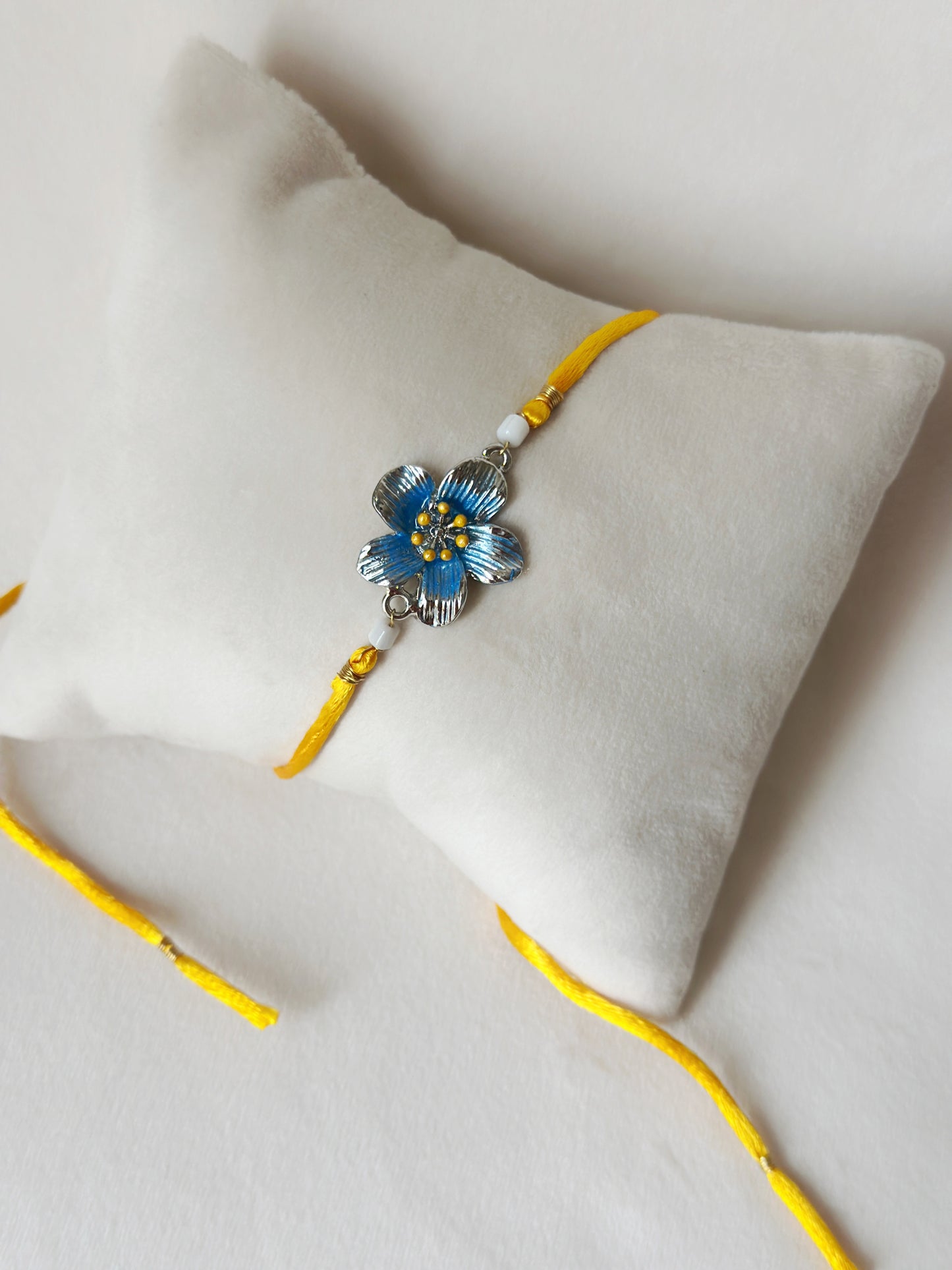 Floral Rakhi Small Silver and saffron