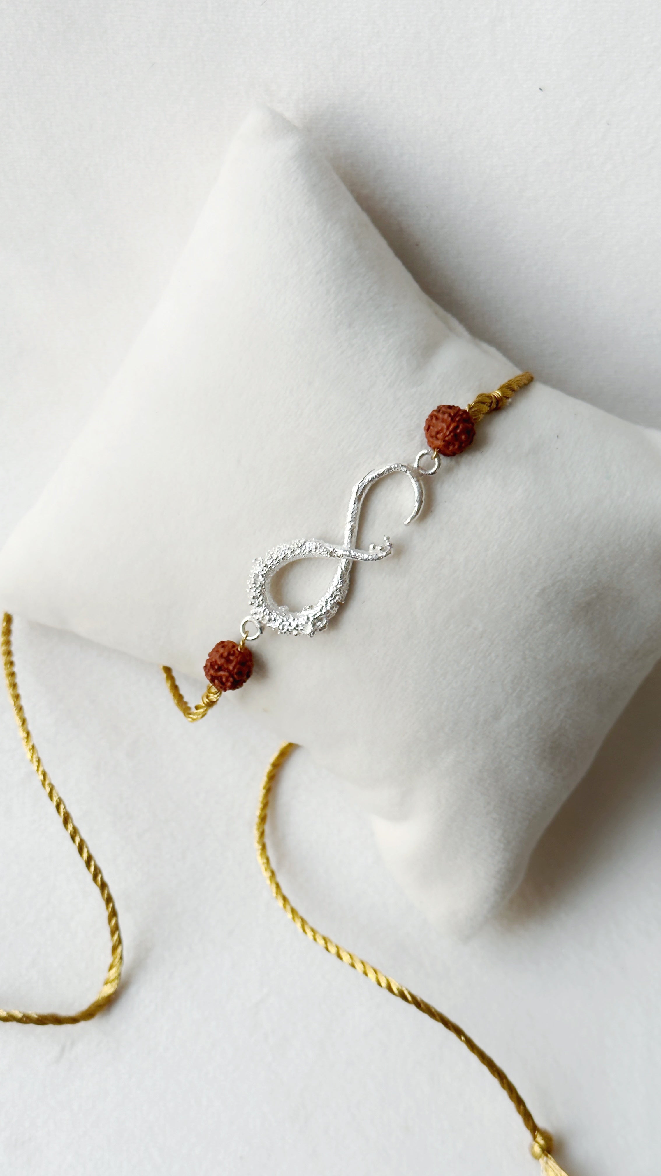 Infinity Rakhi Silver and Gold with Rudraksh beads