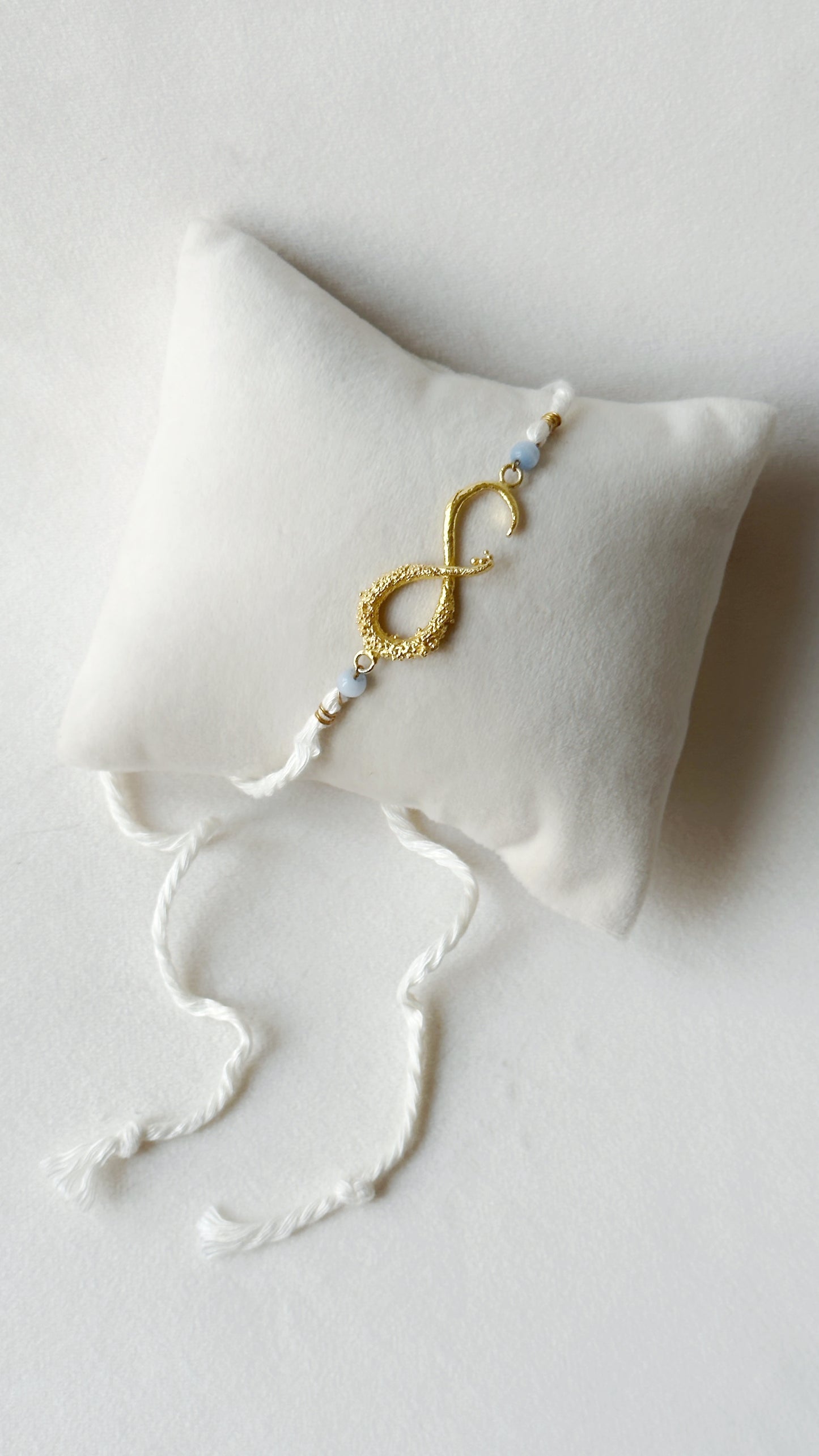 Infinity Rakhi Gold and White
