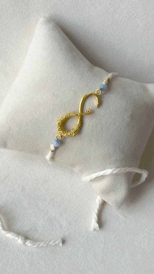 Infinity Rakhi Gold and White