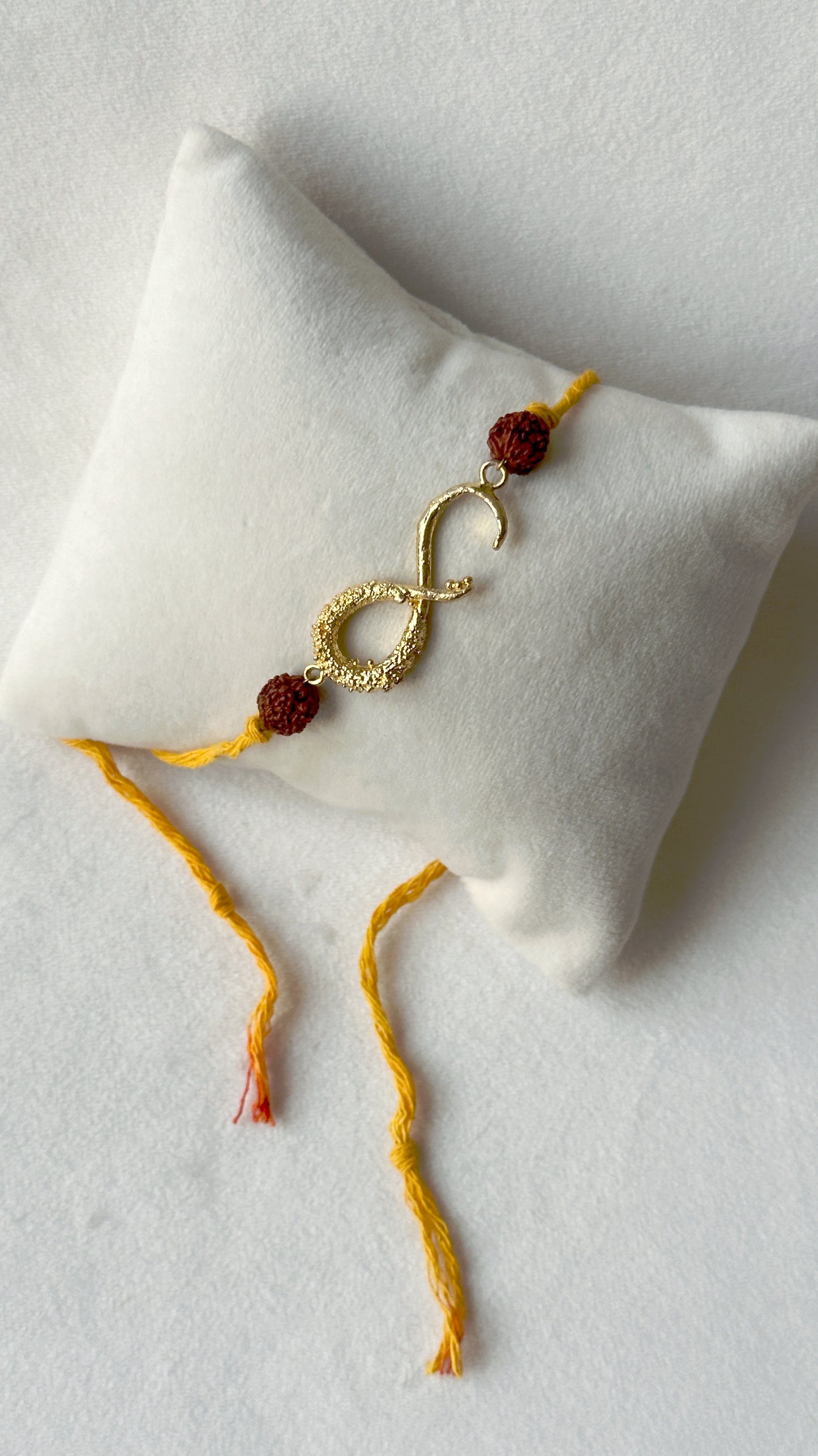 Infinity Rakhi Gold and Saffron with Rudraksh beads