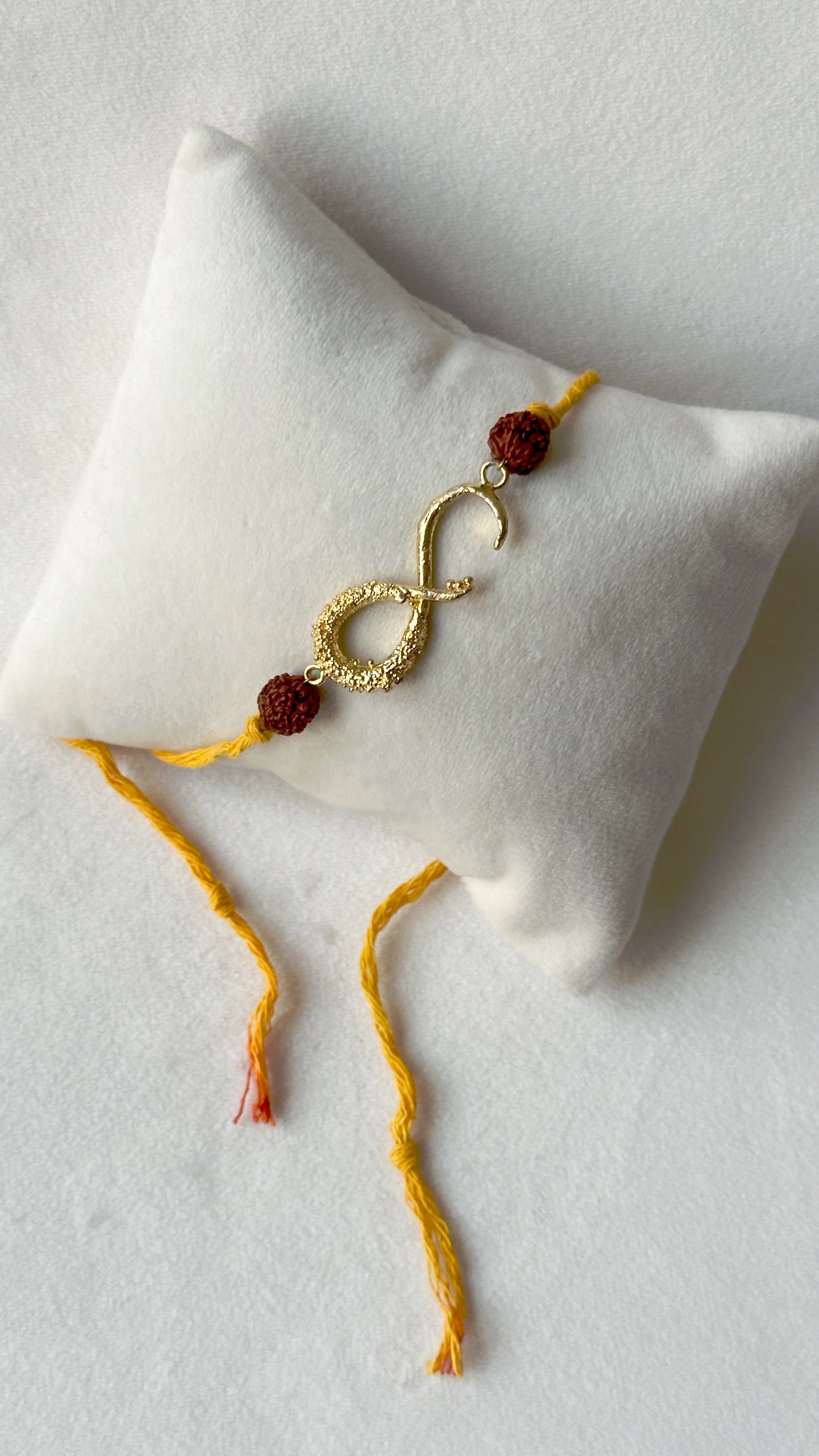 Infinity Rakhi Gold and Saffron with Rudraksh beads