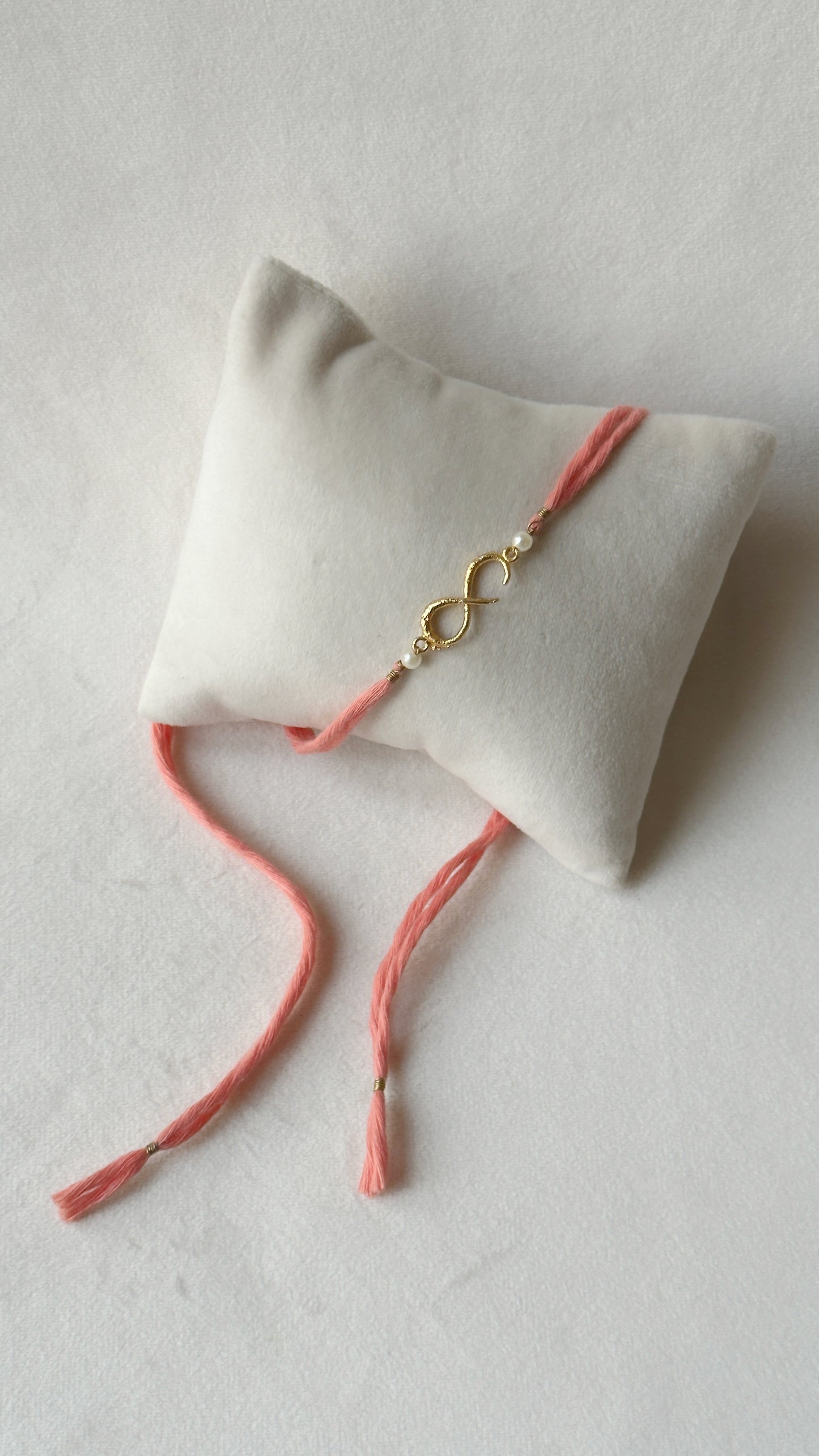 Small Infinity Rakhi Gold and Pink with Pearls