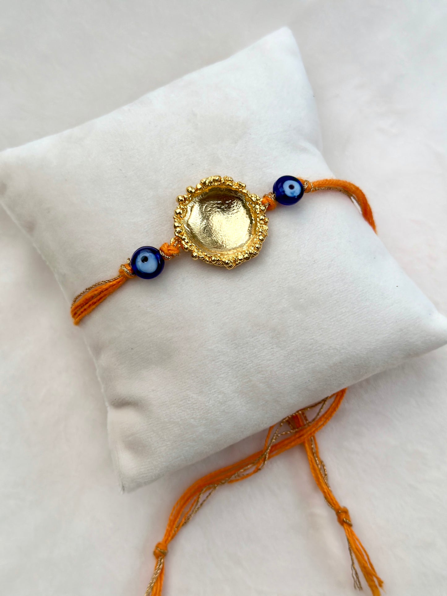 Surya Rakhi Gold and Saffron