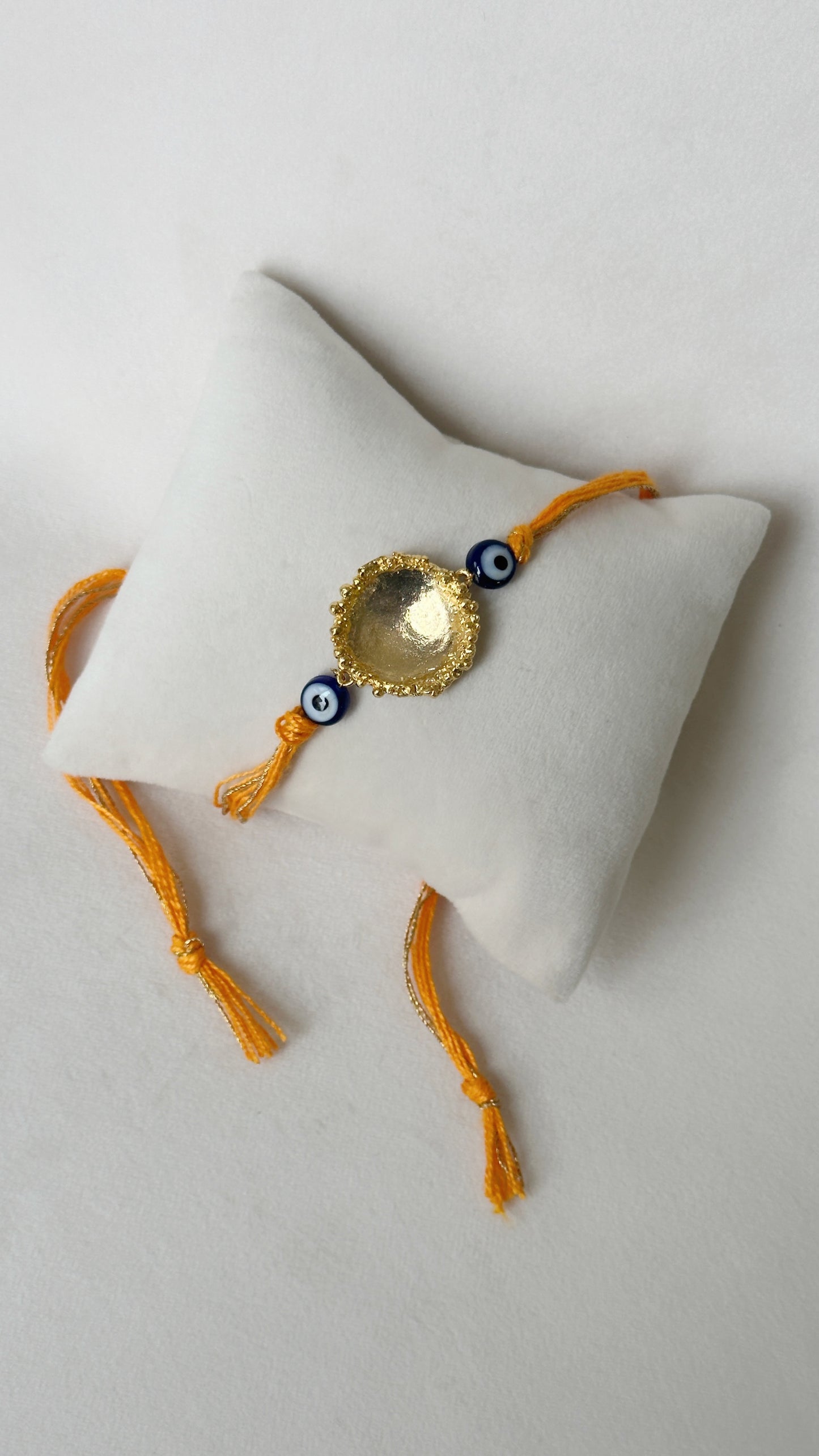 Surya Rakhi Gold and Saffron
