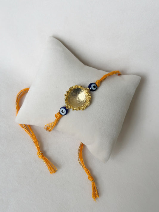 Surya Rakhi Gold and Saffron