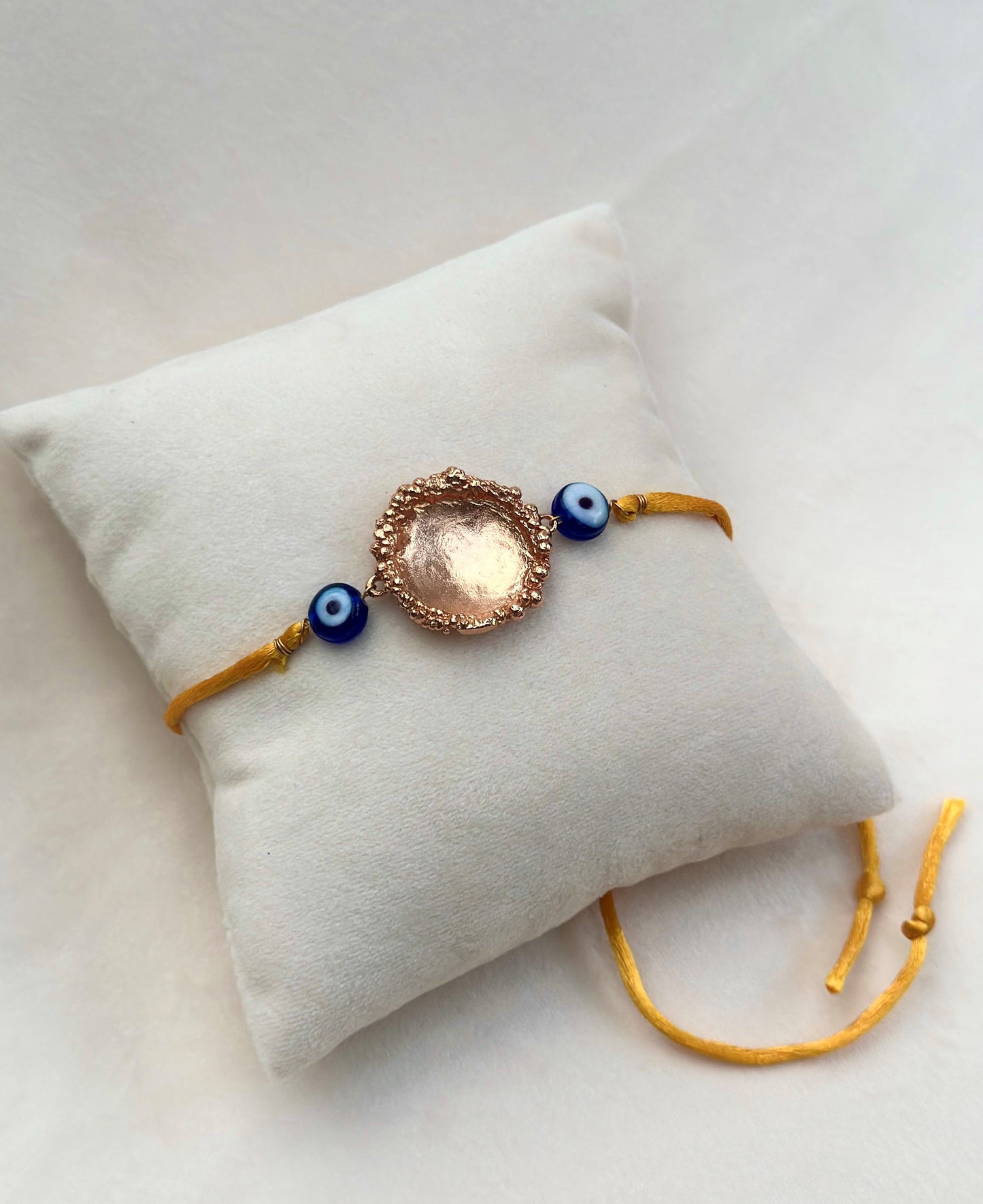 Surya Rakhi Rose Gold and Saffron